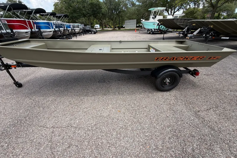 The Image of 2027 Tracker Grizzly 15 Jon boat on trailer, parked outdoors. - 0