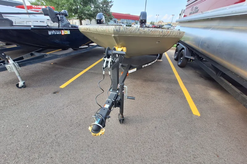 The Image of 2027 Tracker Grizzly 1553 Timber boat on trailer in parking lot. - 0