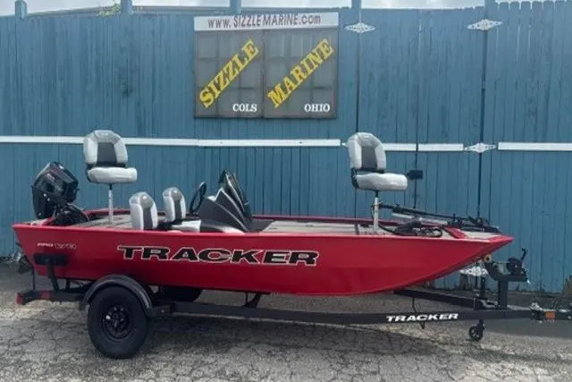 The Image of Red 2027 Tracker Pro 170 boat on trailer, parked in front of Sizzle Marine sign. - 0