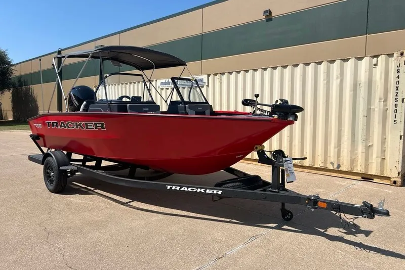 The Image of 2027 Tracker Pro Guide V-175 Combo boat on trailer, red exterior, parked outdoors. - 0