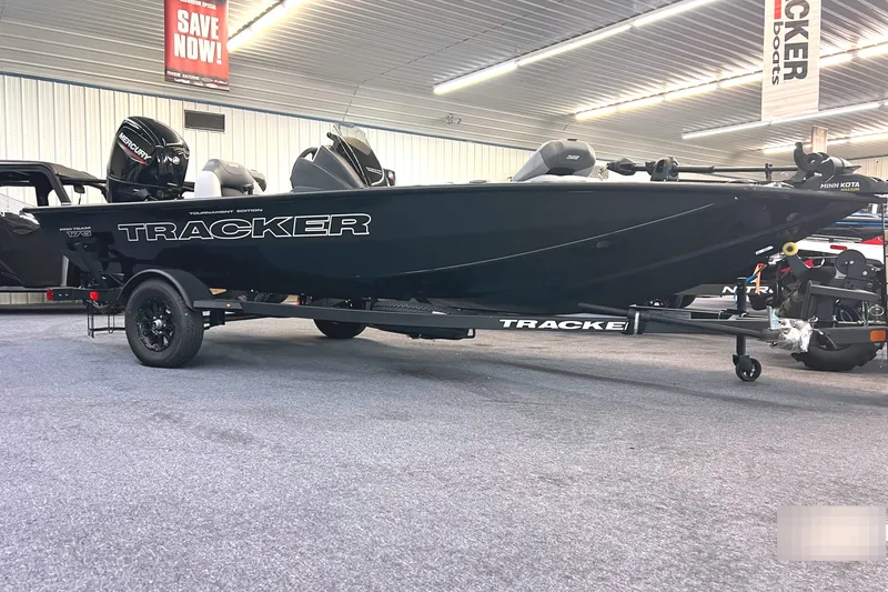 The Image of 2027 Tracker Pro Team 175 boat displayed indoors, featuring sleek black design and modern equipment. - 0