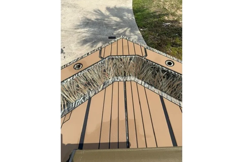Slide: The Image of Bow view of 2027 Tracker Grizzly 1553 Timber boat with camouflage interior design. - 14