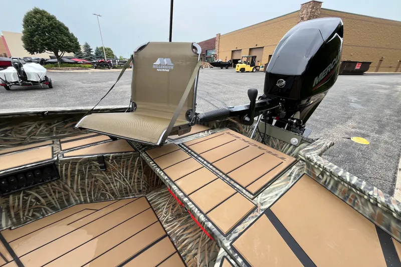 Slide: The Image of 2027 Tracker Grizzly 1553 Timber boat with camo design and Mercury outboard motor. - 25