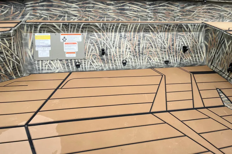 Slide: The Image of Interior of 2027 Tracker Grizzly 1553 Timber boat with camouflage design and tan flooring. - 24