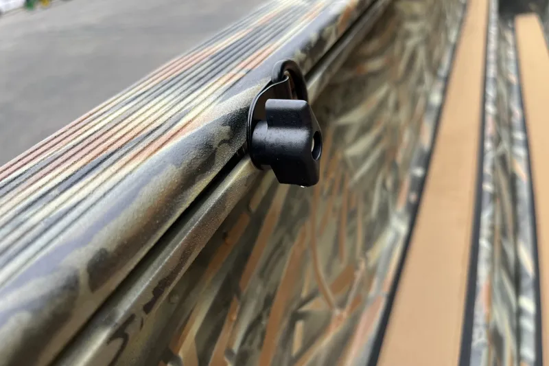 Slide: The Image of Close-up of 2027 Tracker Grizzly 1553 Timber boat with camouflage pattern and black hook detail. - 16