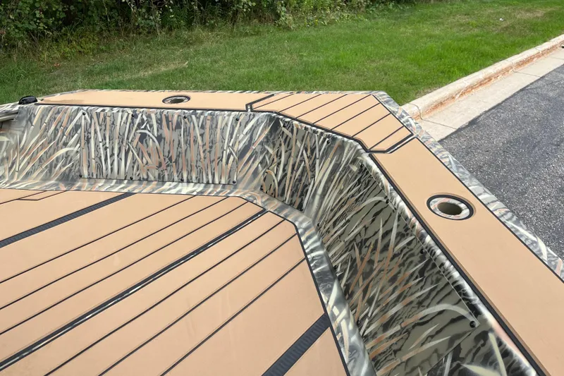 Slide: The Image of 2027 Tracker Grizzly 1553 Timber boat with camo interior and tan decking. - 19