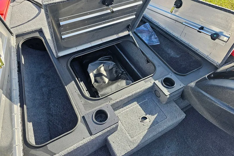 Slide: The Image of 2027 Tracker Pro Team 175 boat interior storage compartments with open lids and cup holders. - 17