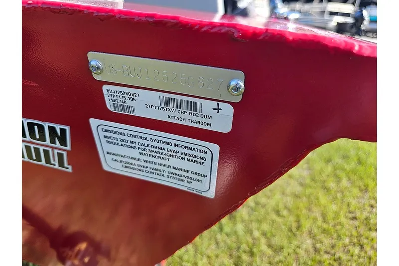 Slide: The Image of 2027 Tracker Pro Team 175 boat identification and emissions control labels on red surface. - 20