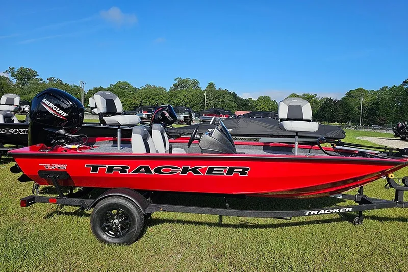 The Image of 2027 Tracker Pro Team 175 boat in vibrant red on a trailer, outdoors. - 1