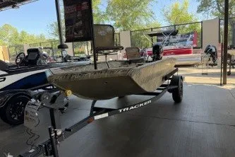 The Image of 2027 Tracker Grizzly 1553 Timber boat on trailer in showroom setting. - 0