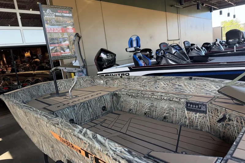 Slide: The Image of 2027 Tracker Grizzly 1553 Timber boat with camouflage design displayed in showroom. - 14