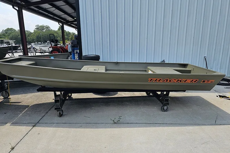 The Image of 2027 Tracker Grizzly 15 Jon boat on display, parked on a wheeled stand. - 1