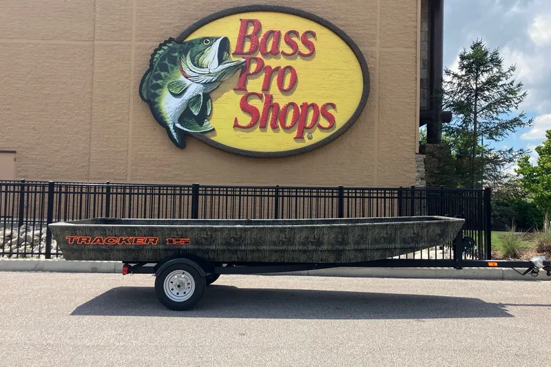 The Image of 2027 Tracker Grizzly 15 Jon boat on trailer outside Bass Pro Shops. - 0
