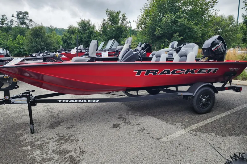 The Image of 2027 Tracker Pro Team 175 boat in vibrant red, parked outdoors on a trailer. - 0