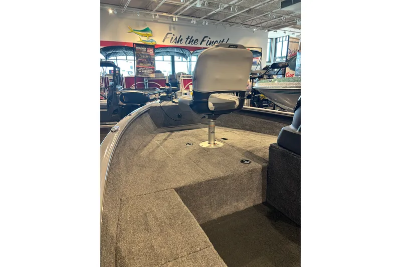 Slide: The Image of 2027 Tracker Super Guide V-16 SC boat interior with seating, displayed in showroom. - 17