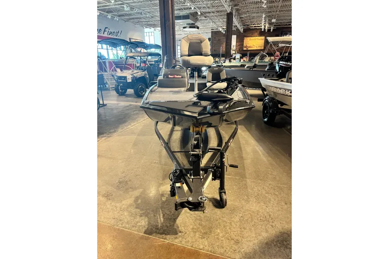 Slide: The Image of 2027 Tracker Super Guide V-16 SC boat displayed in showroom setting. - 16