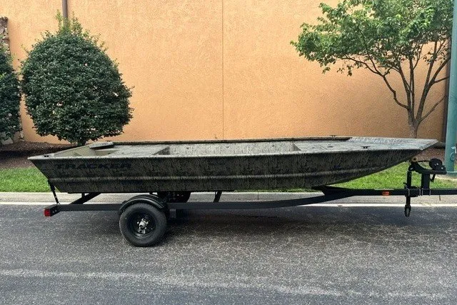 The Image of 2027 Tracker Grizzly 1648 Utility boat on trailer, parked outdoors. - 0