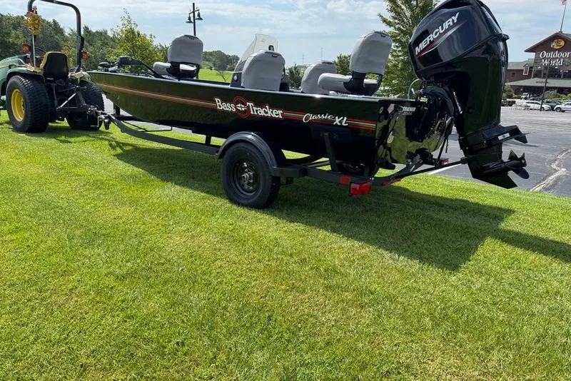 The Image of 2027 Tracker Bass Tracker Classic XL boat on trailer, parked on grass. - 0