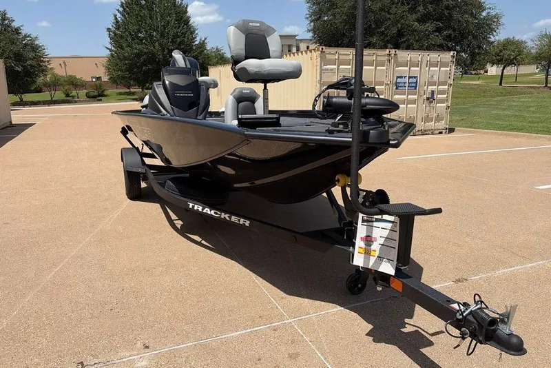 The Image of 2027 Tracker Pro Team 175 boat on trailer in sunny outdoor setting. - 0