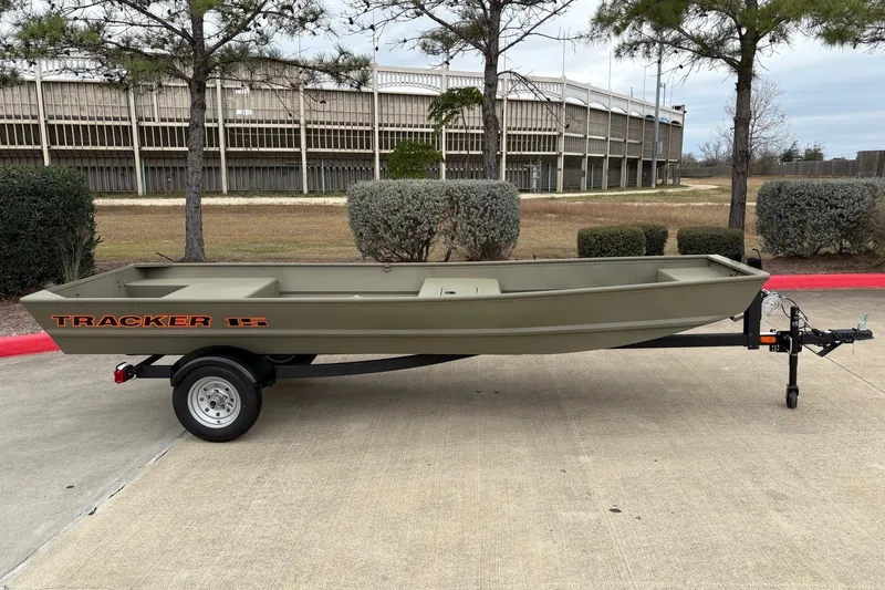The Image of 2027 Tracker Grizzly 15 Jon boat on trailer, parked outdoors. - 0