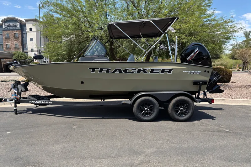 The Image of 2027 Tracker Pro Guide V-175 Combo boat on trailer, parked outdoors. - 0