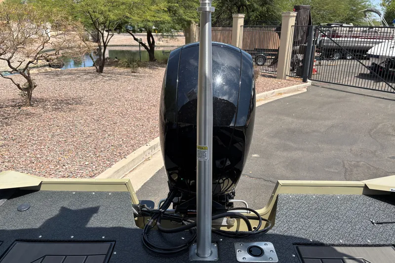 Slide: The Image of 2027 Tracker Pro Guide V-175 Combo boat with outboard motor in a sunny outdoor setting. - 18
