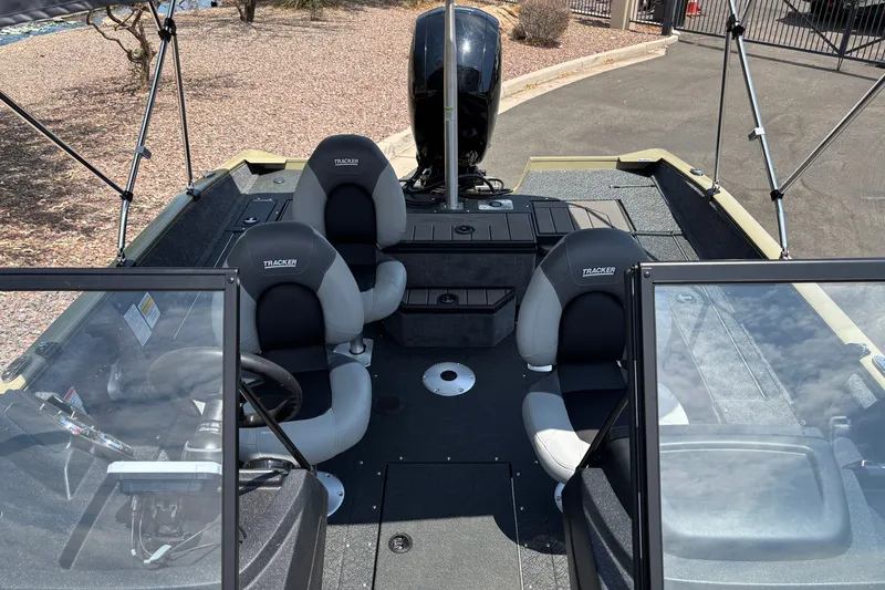 Slide: The Image of 2027 Tracker Pro Guide V-175 Combo boat interior with seating and steering wheel. - 14