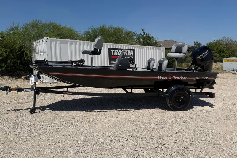 The Image of 2027 Tracker Bass Tracker Classic XL boat on trailer, parked outdoors. - 0