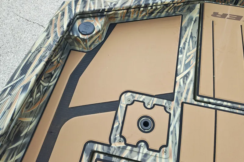Slide: The Image of 2027 Tracker Grizzly 1553 Timber boat deck with camouflage pattern and storage compartments. - 19
