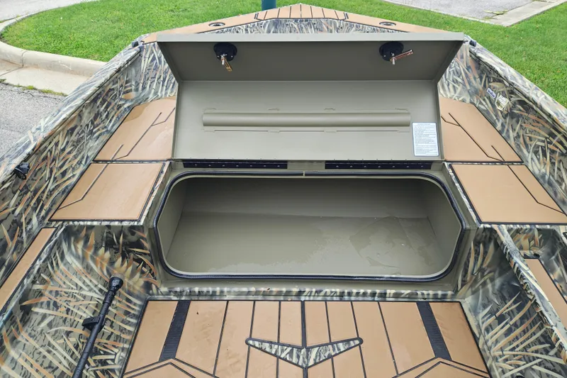 Slide: The Image of 2027 Tracker Grizzly 1553 Timber boat with open storage compartment, camo design. - 16