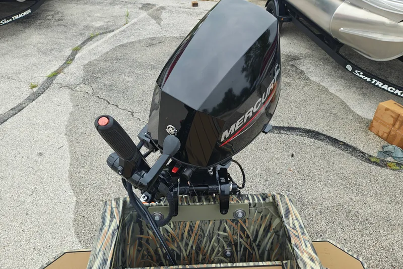 Slide: The Image of Outboard motor on 2027 Tracker Grizzly 1553 Timber boat, parked on concrete. - 20