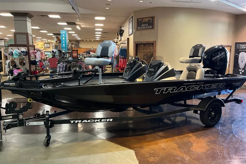 The Image of 2027 Tracker Pro Team 175 boat displayed indoors, featuring Minn Kota and Mercury equipment. - 0