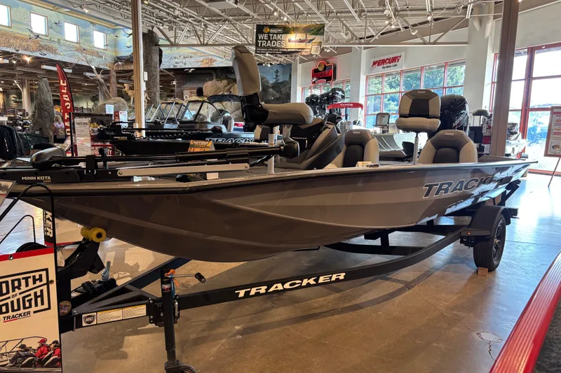 The Image of 2027 Tracker Pro Team 175 boat displayed in showroom, featuring sleek design and comfortable seating. - 0