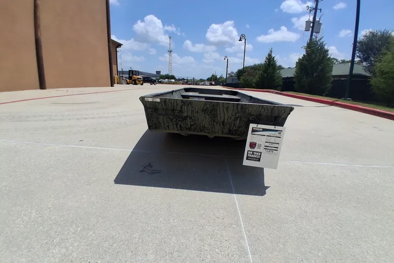 The Image of 2027 Tracker Grizzly 15 Jon boat displayed outdoors on a sunny day. - 0