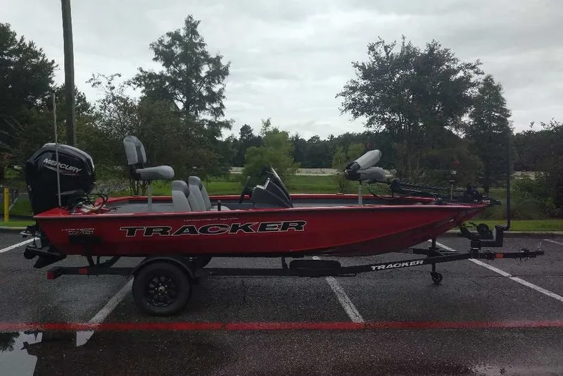 The Image of 2027 Tracker Pro Team 175 boat on trailer in parking lot, overcast day. - 0