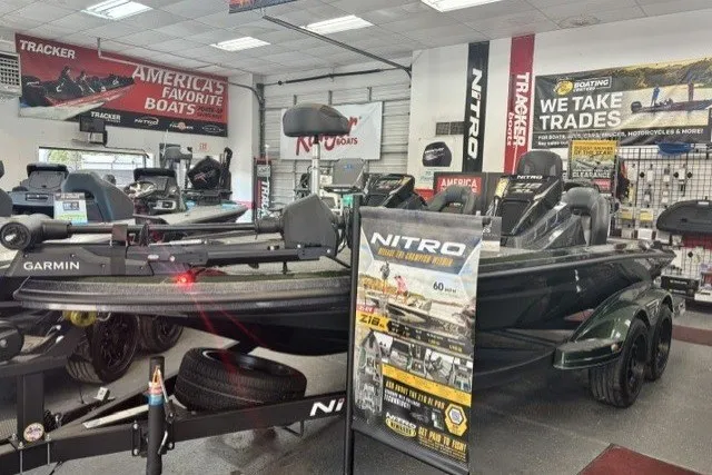 The Image of 2027 Nitro Z18 XL Pro boat displayed in showroom with promotional banners. - 0