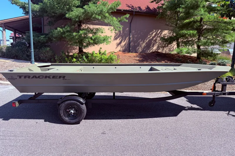 Slide: The Image of 2027 Tracker Grizzly 1648 Utility boat on trailer, parked outdoors. - 19