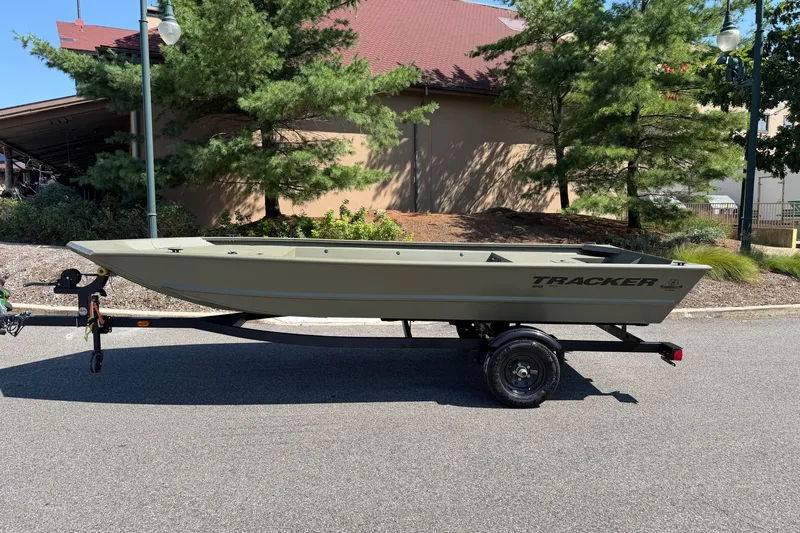 The Image of 2027 Tracker Grizzly 1648 Utility boat on trailer, parked outdoors. - 0