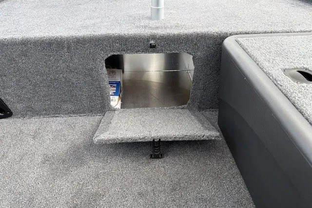 Slide: The Image of 2027 Tracker Bass Tracker Classic XL boat storage compartment with carpeted interior. - 36