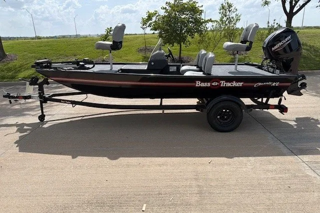 The Image of 2027 Tracker Bass Tracker Classic XL boat on trailer, parked outdoors. - 23