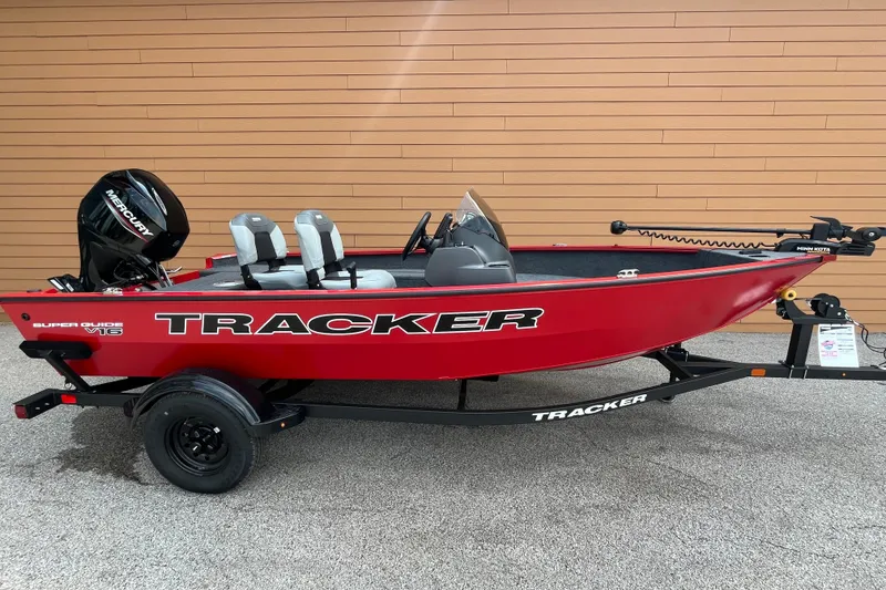 The Image of 2027 Tracker Super Guide V-16 SC boat, red with Mercury motor, on trailer. - 0