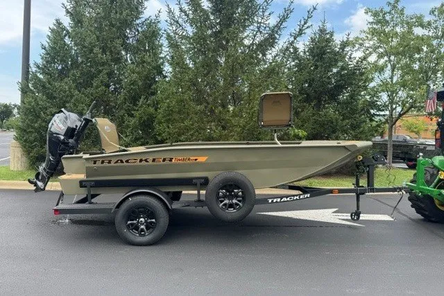 The Image of 2027 Tracker Grizzly 1553 Timber boat on trailer, parked outdoors. - 0