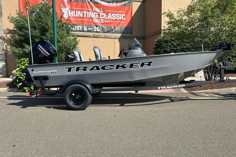 The Image of 2027 Tracker Super Guide V-16 SC boat on trailer, displayed outdoors. - 0