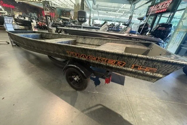 The Image of 2027 Tracker Grizzly 15 Jon boat displayed in showroom with camo design. - 0