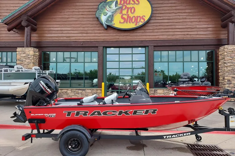 The Image of Red 2027 Tracker Super Guide V-16 SC boat displayed at Bass Pro Shops. - 0