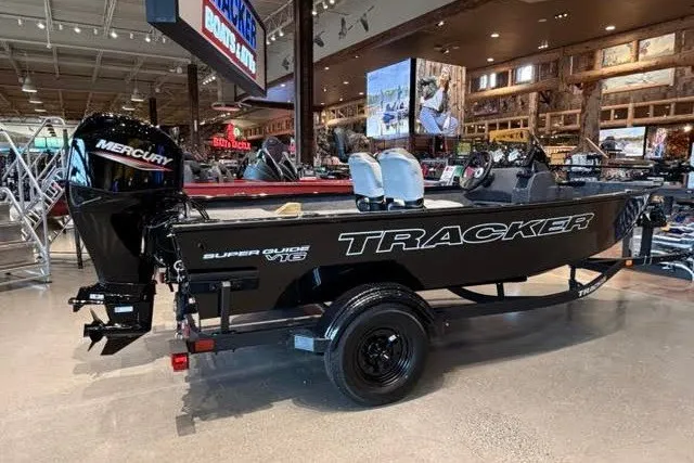 The Image of 2027 Tracker Super Guide V-16 SC boat displayed indoors with Mercury engine. - 0