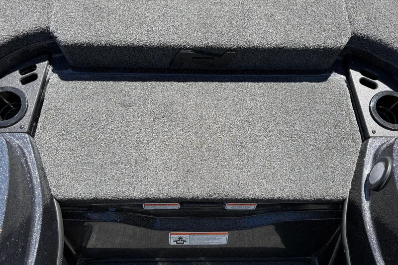 Slide: The Image of Carpeted deck of a 2027 Nitro Z18 XL boat, featuring cup holders and storage compartments. - 43