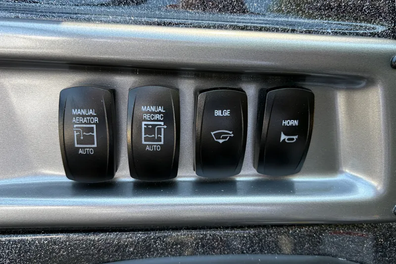 Slide: The Image of Control panel switches on a 2027 Nitro Z18 XL boat dashboard. - 29