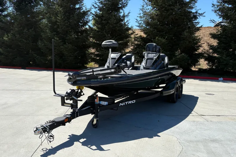 Slide: The Image of 2027 Nitro Z18 XL fishing boat on trailer, parked outdoors. - 8