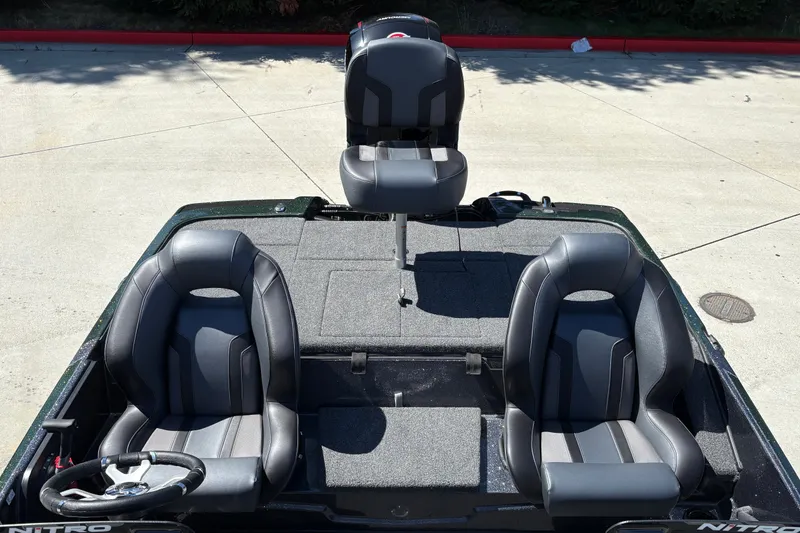 Slide: The Image of 2027 Nitro Z18 XL boat interior with three black seats and steering wheel. - 26